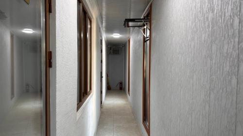 an empty hallway with a long aisle with a hallwayngthngthngthngthngthngth at УЮТ отель и хостел in Jalal-Abad