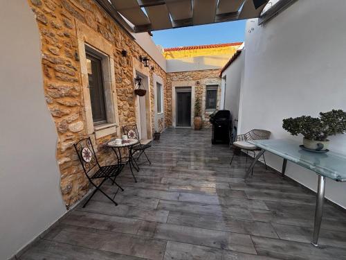 a hallway with a table and chairs in a building at Villa Katrinia in Sitia