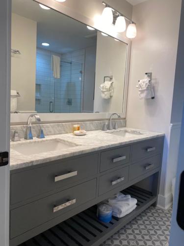 a bathroom with a sink and a large mirror at 417 Seascape Villas, Beachfront! Stunning Views! Pool! in Isle of Palms