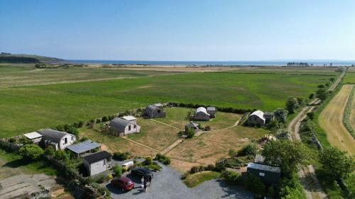an aerial view of a farm with a group of tents at The Galloway Steading - The Fox's Den with Hot Tub and Fire Pit in Glenluce