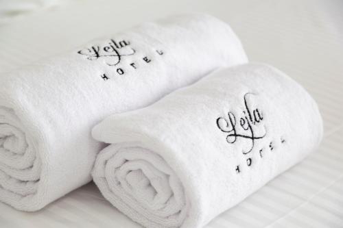 a roll of white towels with writing on them at Hotel Lejla in Ulcinj