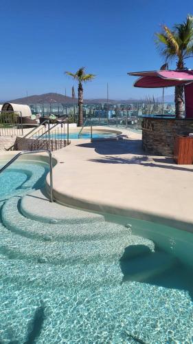 a swimming pool with palm trees in the background at 3 bed Ocean Spa Plaza Luxurious flat in Gibraltar