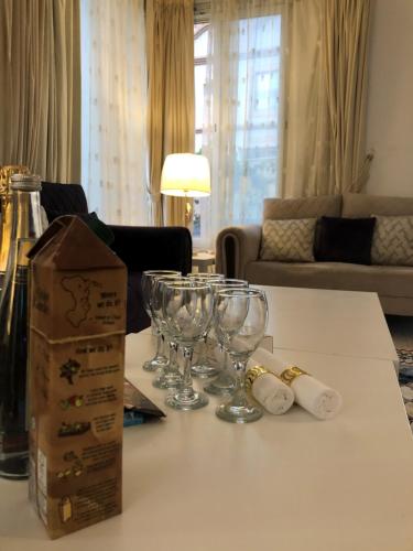 a table with wine glasses and a box on it at نزل فلل الريف alreef villas in Baljurashi