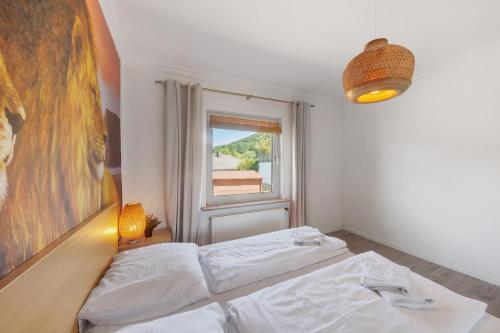 a bedroom with two beds and a window at db staycation ferienpark in Niedenstein