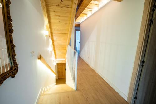 a staircase in a house with a wooden ceiling at House in the Old Town of Marbella with Private Pool and Free Parking in Marbella