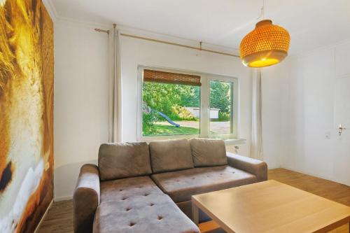 a living room with a couch and a table at db staycation ferienpark in Niedenstein