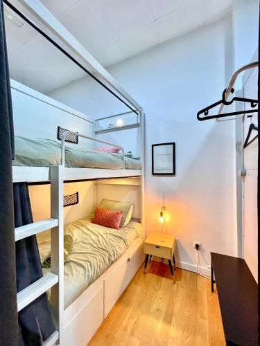 a small room with bunk beds and a desk at Hostel Time Life in Nerja