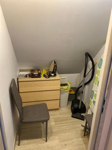 a room with a desk and a chair and a dresser at Domek z basenem in Kodrąb