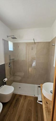 a bathroom with a shower and a toilet and a sink at Camping Ermosa in Posada