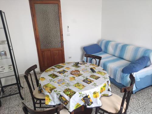 a living room with a table and a couch at Al Municipio in Sperlinga