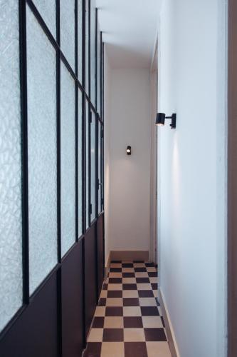 a hallway with a door and a checkered floor at Altoledo Rooms and Suite in Naples