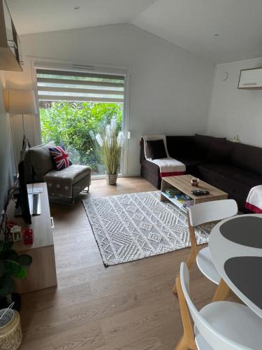 a living room with a couch and a table at Premium Chalet A in Ebenzweier