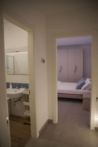 a view of a bedroom with a bed and a sink at Celsius Home in Lecce