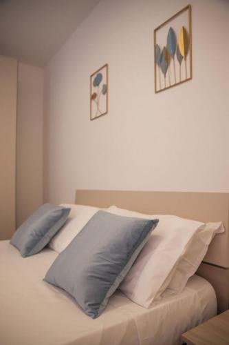 a bed with three pillows on top of it at Celsius Home in Lecce
