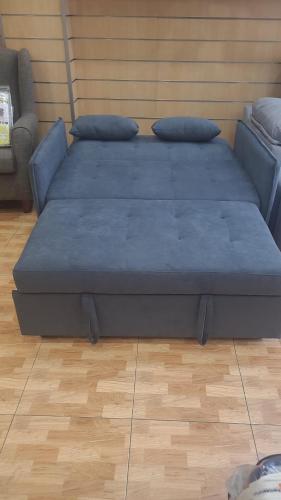 a bed with two pillows on it in a room at Edificio La Biznaga PQ in Málaga