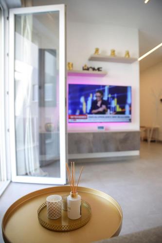 a coffee table in a living room with a tv at Celsius Home in Lecce