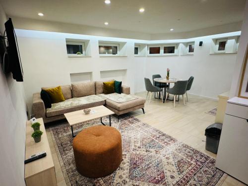 a living room with a couch and a table at White Shell Sarajevo - Cozy & Stylish Apartment in Old Town in Sarajevo