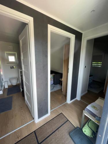an empty room with two open doors and a bathroom at Premium Chalet A in Ebenzweier