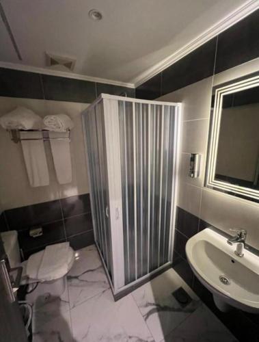 a bathroom with a shower and a sink at WOW Pyramids Inn With Rooftop Lounge in Cairo