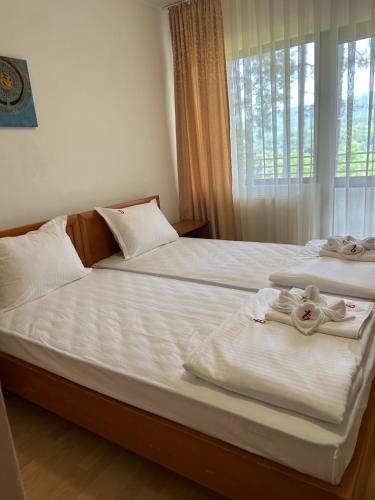 two beds in a room with towels on them at Park Hotel Panorama in Tryavna