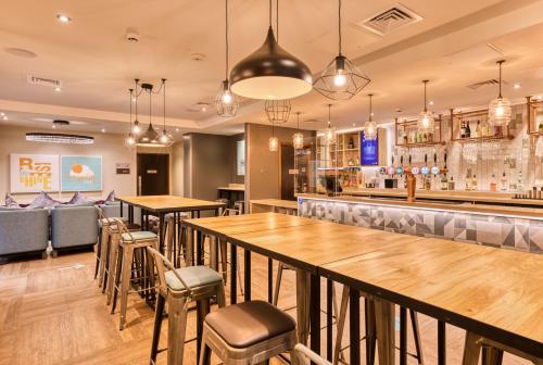 a restaurant with tables and chairs and a bar at Premier Inn Dublin City Temple Bar in Dublin
