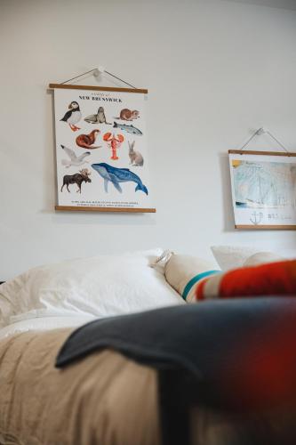 a bedroom with a picture of animals on the wall at Homeport Suites & Residences in Lords Cove 