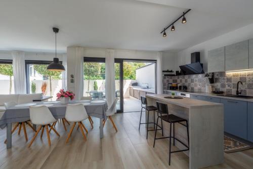a kitchen and dining room with a table and chairs at Villa Ventana with terrace and BBQ in Savudrija