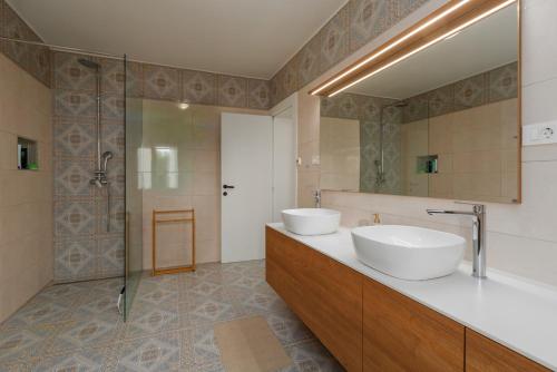 a bathroom with two sinks and a shower at Villa Ventana with terrace and BBQ in Savudrija