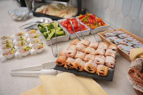 a buffet of food with pastries and other foods at Hegyi Panzió in Szilvásvárad