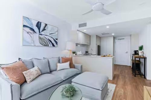 a living room with a couch and a table at Elevate Brisbane City - Views, Pool, Sauna & Gym in Brisbane