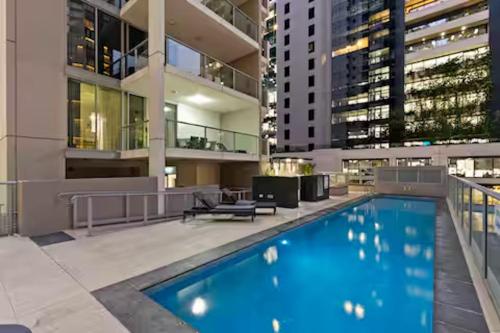 a swimming pool in the middle of a building at Elevate Brisbane City - Views, Pool, Sauna & Gym in Brisbane