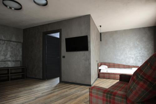 a living room with a bed and a couch at Crimea Wine Hotel in Chiavenna
