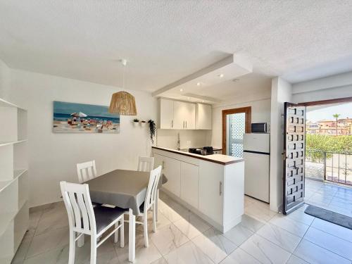 a kitchen and dining room with a table and chairs at Appartement AMALIA in Orihuela Costa