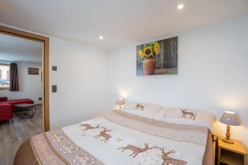 a bedroom with a bed with a blanket on it at Chalet Morgenrot in Arni Alp
