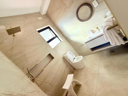 an overhead view of a bathroom with a sink and a toilet at 19 On BayNoakes Boutique in Harare