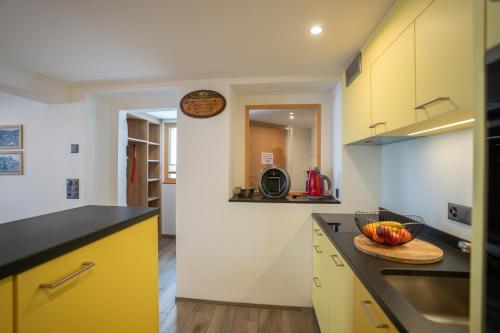 a kitchen with a bowl of fruit on a counter at Chalet Morgenrot in Arni Alp