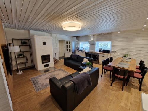 a large living room with a couch and a table at Rõmeda puhkemaja saunaga in Rõmeda