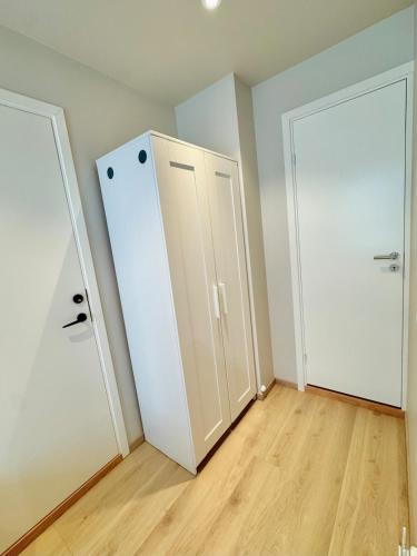 an empty room with two white doors and a wooden floor at Smart & Central - New Renovated in Oslo