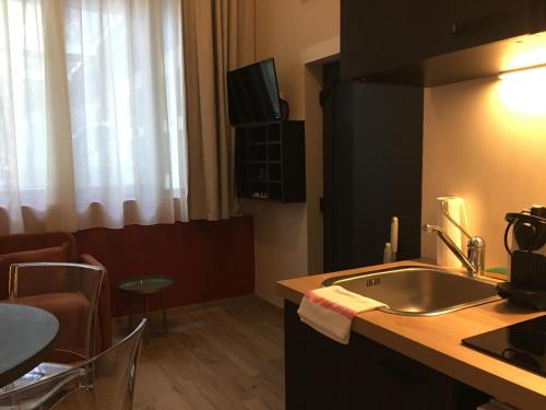 a kitchen with a sink and a counter top at Smartappart Niort in Niort