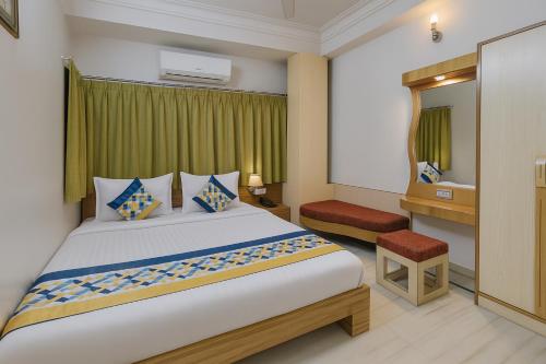 a bedroom with a large bed and a bathroom at The Sky Comfort Hotel Shreenath - 10 Meters from Shreenathji Temple in Nāthdwāra