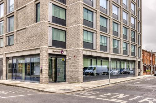 a large brick building on a city street at Premier Inn Dublin City Gloucester St South in Dublin