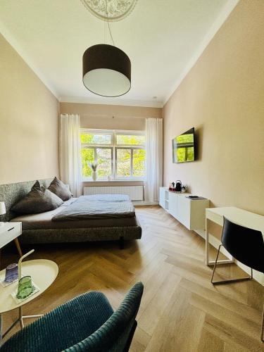 a living room with a bed and a couch at Pension Am Sültebrunnen in Bad Oeynhausen