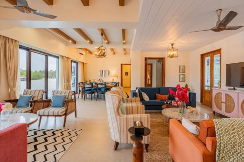 a living room with couches and chairs at Villa Fleuve 6-BHK Riverfront Hideaway With Infinity Pool & Bathtub in Nerul
