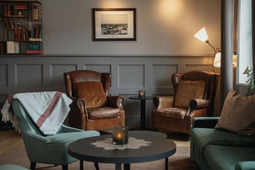 a living room with two chairs and a table at Home Hotel Uman in Umeå