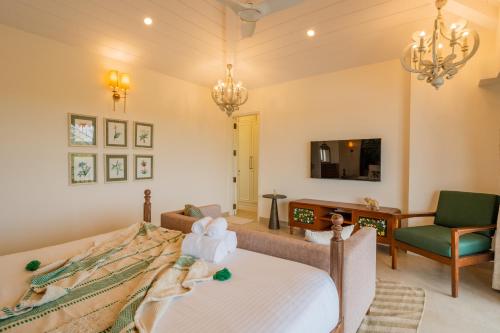 a bedroom with a bed and a living room at Villa Fleuve 6-BHK Riverfront Hideaway With Infinity Pool & Bathtub in Nerul