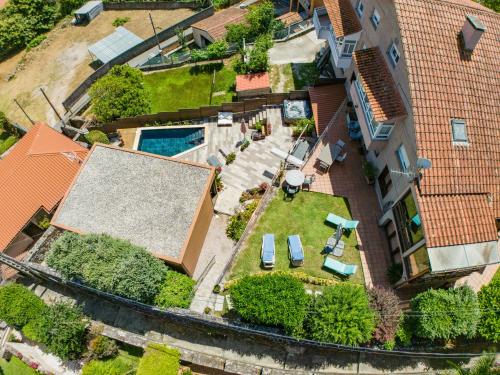 an aerial view of a house with a yard with a swimming pool at CABAÑA VILA DO MAR in Baiona