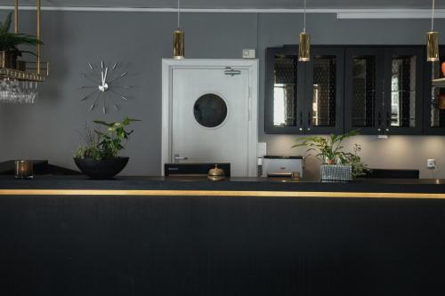 a counter with potted plants on top of it at Home Hotel Uman in Umeå