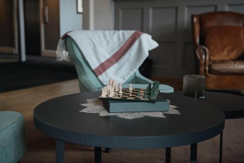 a chess board on a table in a living room at Home Hotel Uman in Umeå