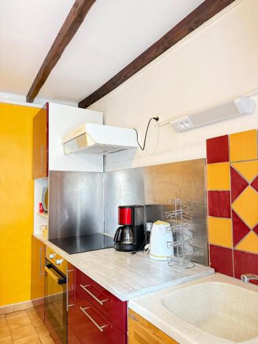 a kitchen with a sink and a counter top at Le Cocon D'Alembert in Arles