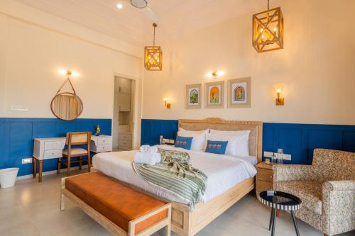 a bedroom with a large bed and a chair at Villa Fleuve 6-BHK Riverfront Hideaway With Infinity Pool & Bathtub in Nerul